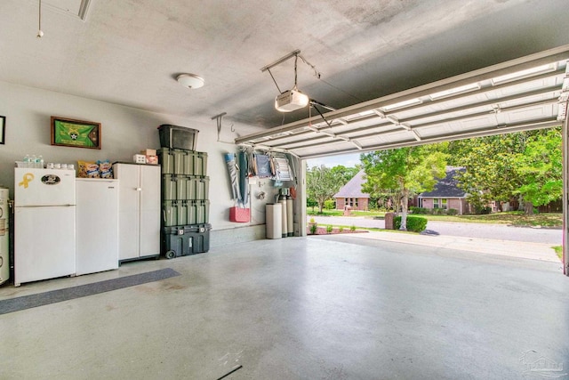 905 Shadow Ridge Dr, Pensacola, FL 32514 - garage featuring freestanding refrigerator and a garage door opener