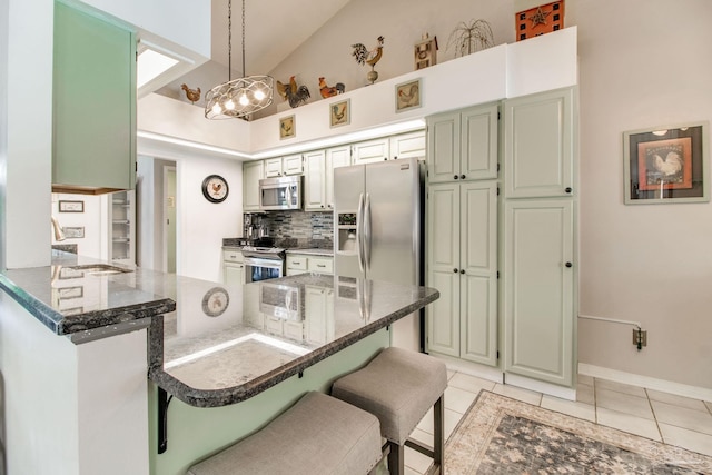 905 Shadow Ridge Dr, Pensacola, FL 32514 - kitchen featuring appliances with stainless steel finishes, a kitchen breakfast bar, a peninsula, a chandelier, and light tile patterned flooring