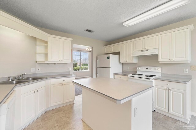 1978 Coral Reef Rd, Pensacola, FL 32506 - kitchen with white appliances, a sink, under cabinet range hood, open shelves, and a textured ceiling