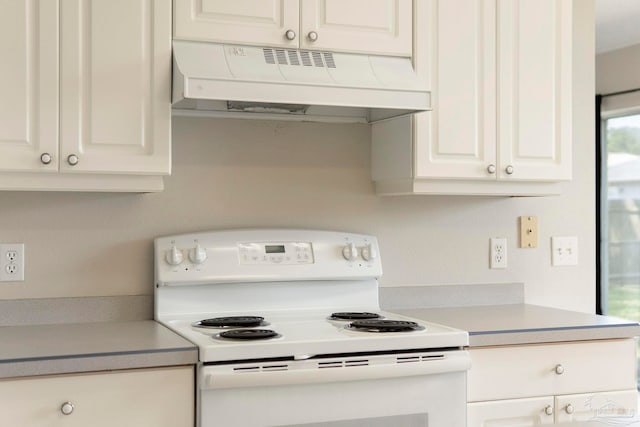 1978 Coral Reef Rd, Pensacola, FL 32506 - kitchen with white electric stove, under cabinet range hood, light countertops, and white cabinetry