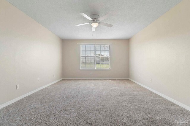 1978 Coral Reef Rd, Pensacola, FL 32506 - carpeted empty room featuring a textured ceiling, ceiling fan, and baseboards