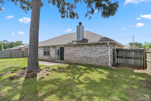 1978 Coral Reef Rd, Pensacola, FL 32506 - rear view of house with brick siding, a chimney, a patio area, and roof with shingles