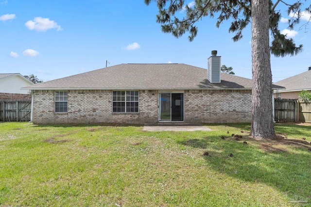 1978 Coral Reef Rd, Pensacola, FL 32506 - back of property with brick siding, a chimney, a patio area, and a shingled roof