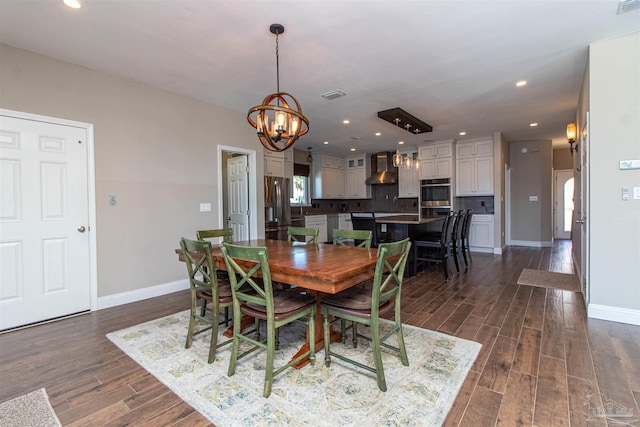 dining space featuring dark wood finished floors, baseboards, a notable chandelier, visible vents, and recessed lighting