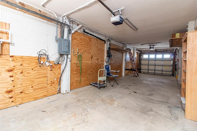 garage with electric panel and a garage door opener