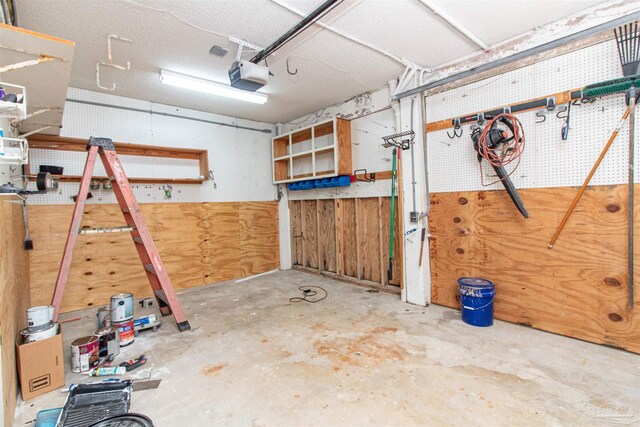 garage with a workshop area and a garage door opener