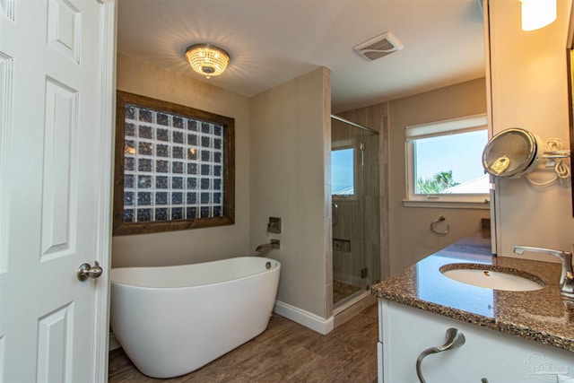 bathroom featuring separate shower and tub, wood-type flooring, and vanity