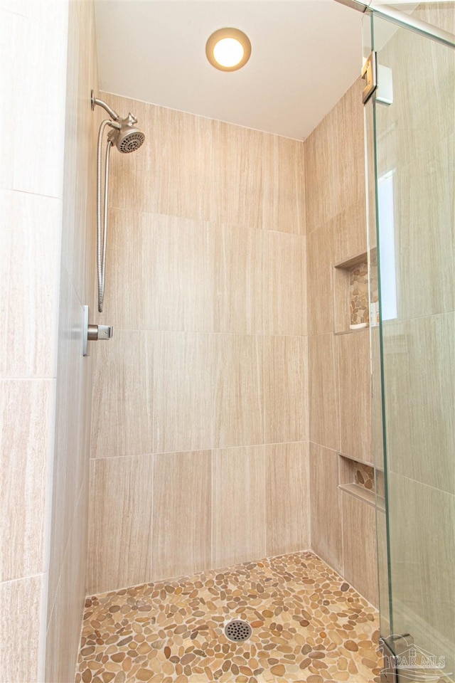 bathroom with tiled shower