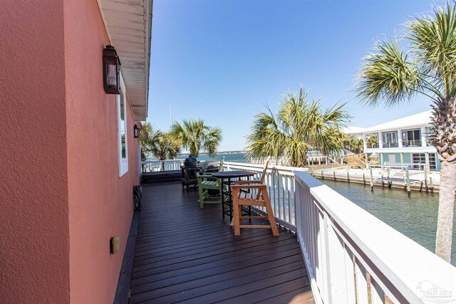 deck featuring a boat dock and a water view