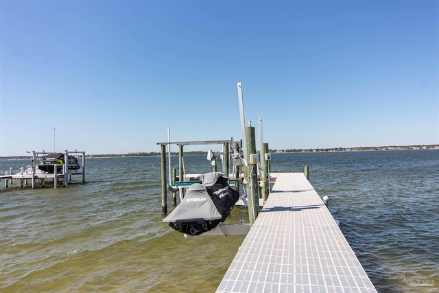 view of dock featuring boat lift and a water view