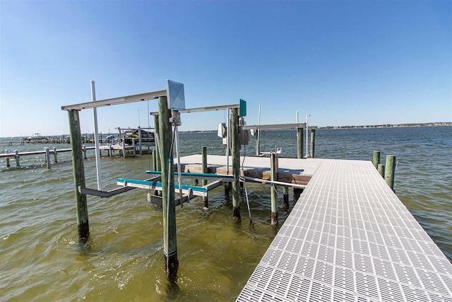 dock area with a water view and boat lift