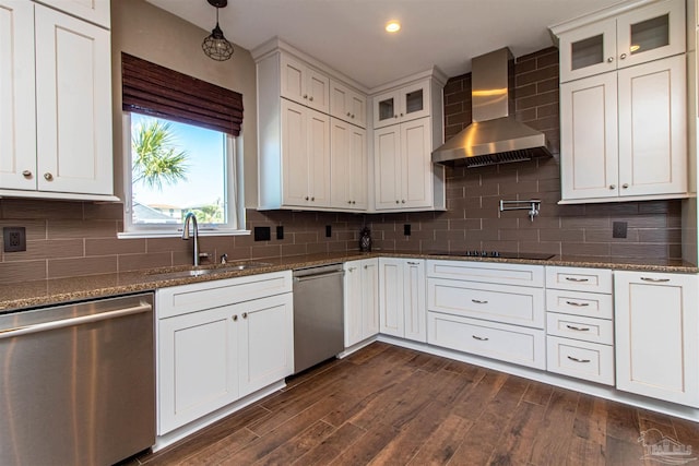 kitchen with wall chimney range hood, stainless steel dishwasher, decorative backsplash, and dark hardwood / wood-style floors