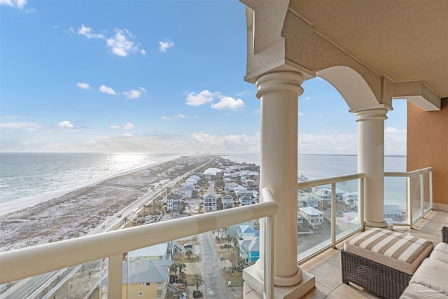 balcony with a beach view and a water view