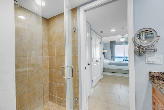 bathroom with tile patterned flooring, vanity, and a shower with shower door