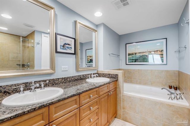 bathroom with vanity and separate shower and tub