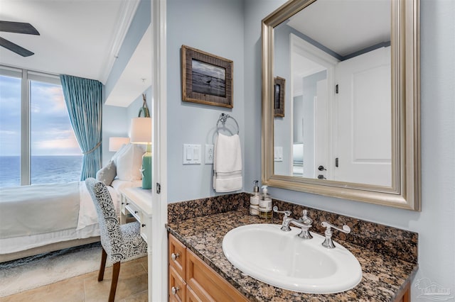 bathroom with tile patterned flooring, vanity, and a water view