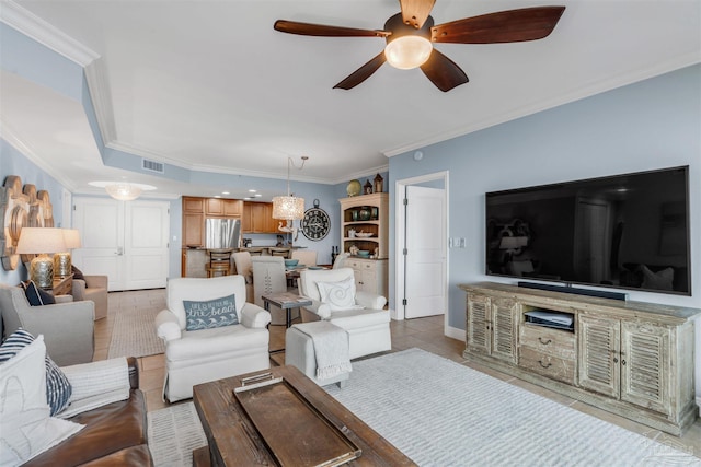 tiled living room with ornamental molding and ceiling fan