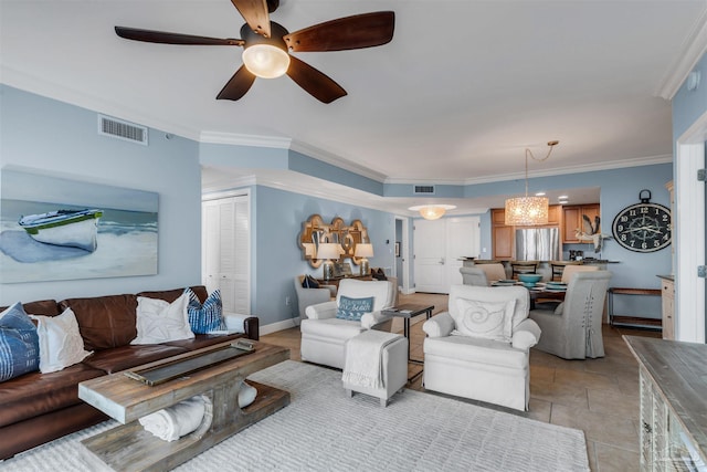 tiled living room with ornamental molding and ceiling fan with notable chandelier