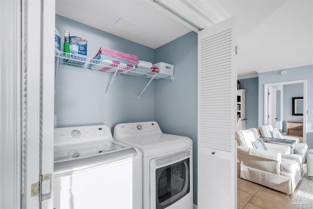 laundry area with light tile patterned floors and washing machine and dryer