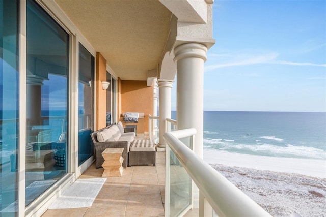 balcony with a beach view and a water view