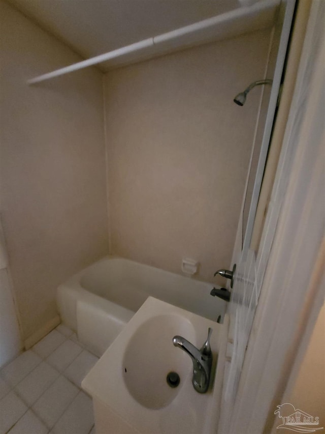 bathroom with tile patterned flooring and tub / shower combination