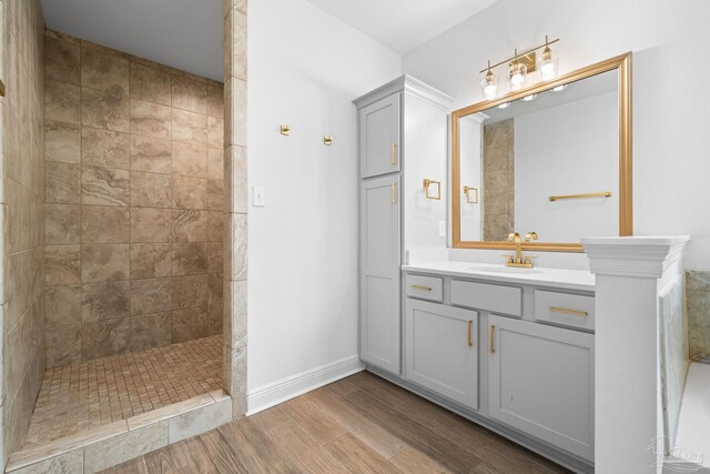 bathroom with vanity and tiled shower