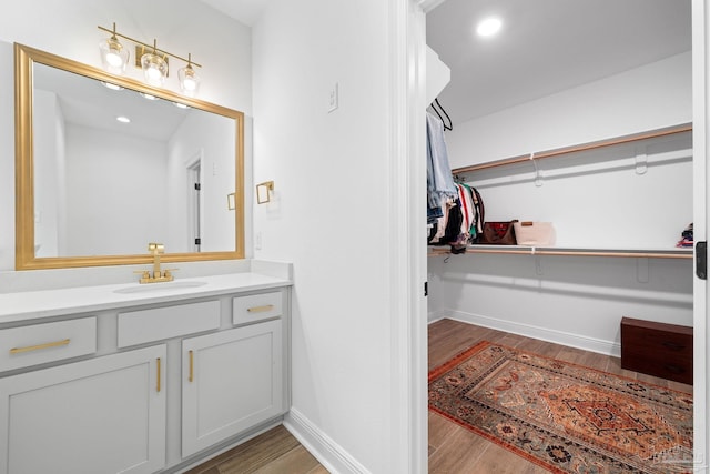 bathroom with vanity and wood-type flooring