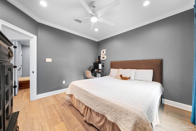 bedroom featuring crown molding, light hardwood / wood-style flooring, and ceiling fan