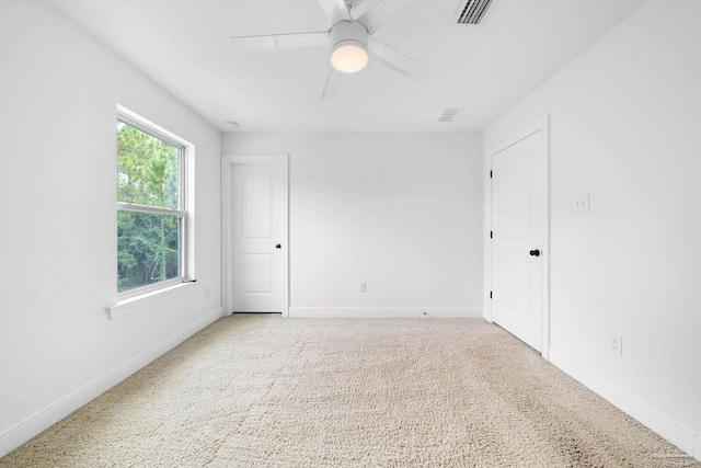 spare room with light carpet and ceiling fan