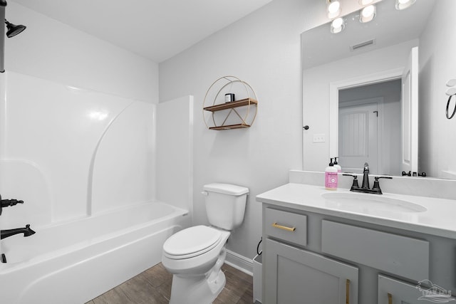 full bathroom featuring vanity, toilet, hardwood / wood-style flooring, and shower / bathing tub combination