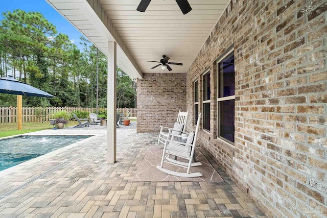 view of patio / terrace featuring a fenced in pool and ceiling fan