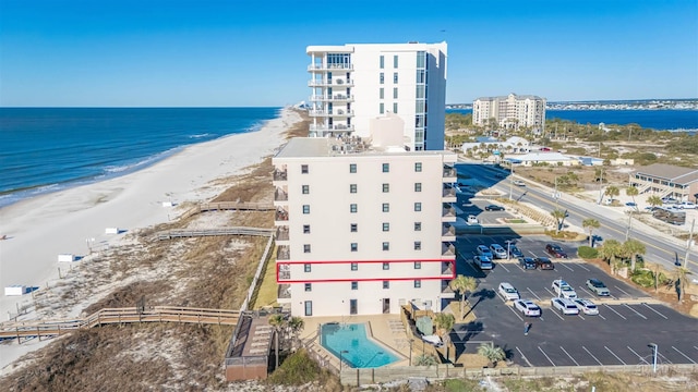 drone / aerial view featuring a beach view and a water view