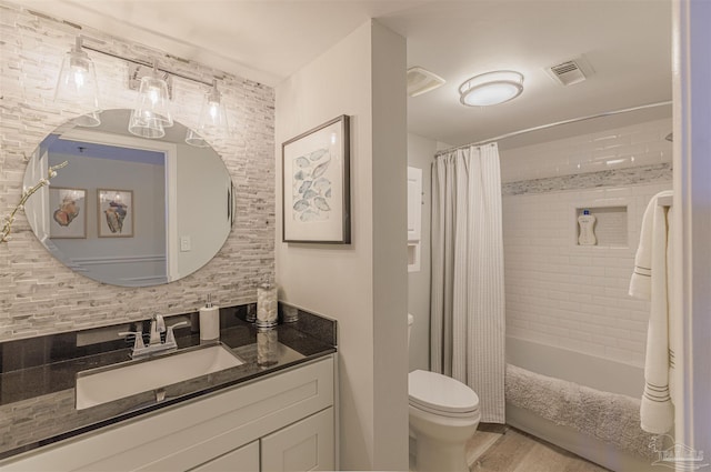 bathroom with visible vents, shower / bath combo with shower curtain, toilet, backsplash, and vanity