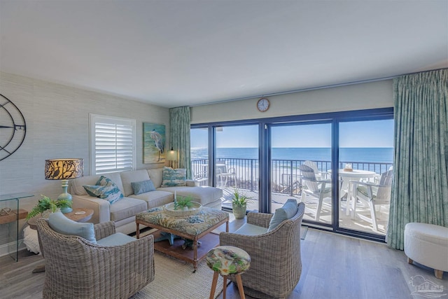 living area with a water view and wood finished floors