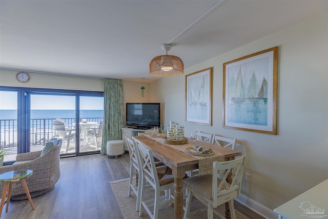 dining area with wood finished floors and baseboards