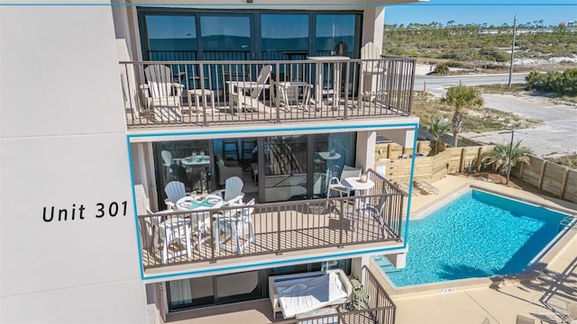 community pool featuring a patio and fence