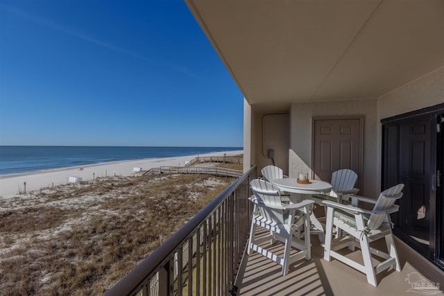 balcony featuring a water view and a view of the beach