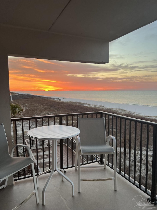 balcony featuring a water view and a view of the beach