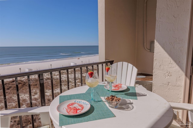 balcony featuring a beach view and a water view