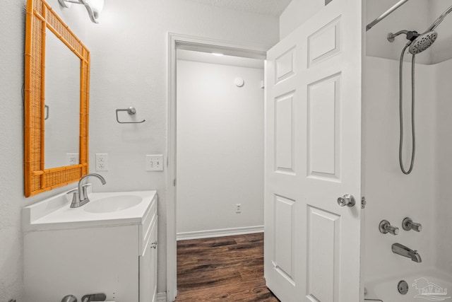 bathroom with vanity, wood-type flooring, and washtub / shower combination