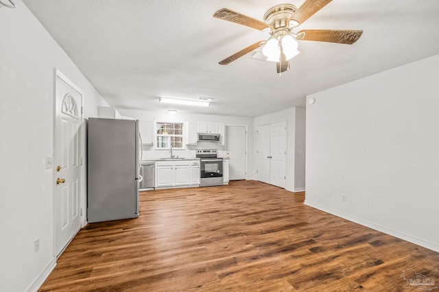 kitchen featuring white cabinets, stainless steel appliances, hardwood / wood-style flooring, and ceiling fan