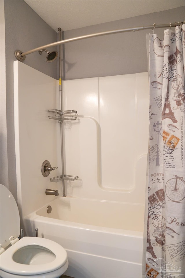 bathroom with shower / bath combo with shower curtain and toilet