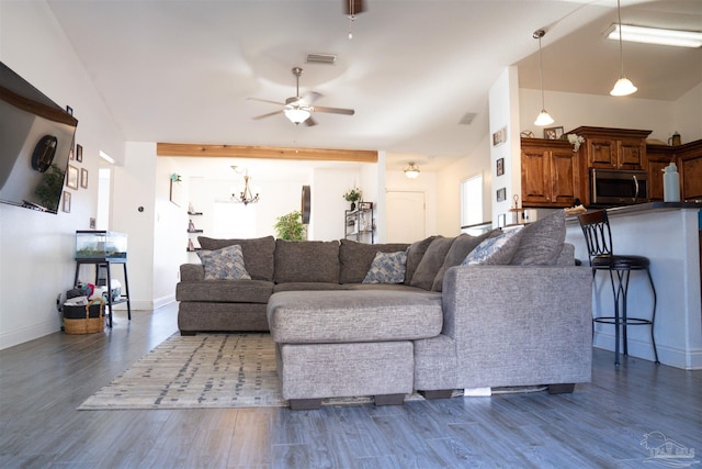 living room featuring ceiling fan with notable chandelier, plenty of natural light, dark hardwood / wood-style floors, and beam ceiling