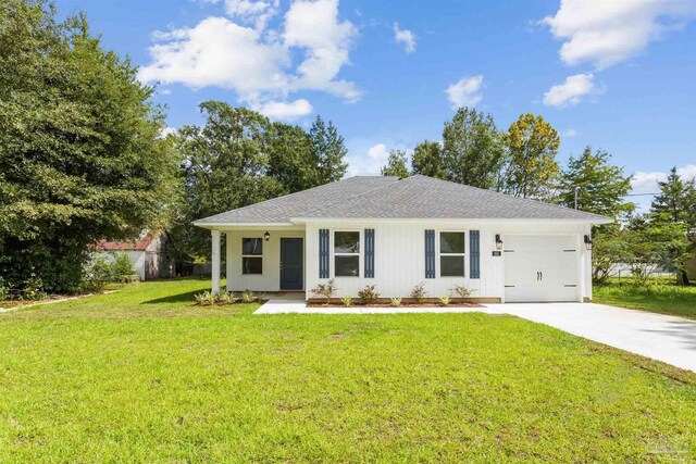 view of front of home with a front lawn and a garage