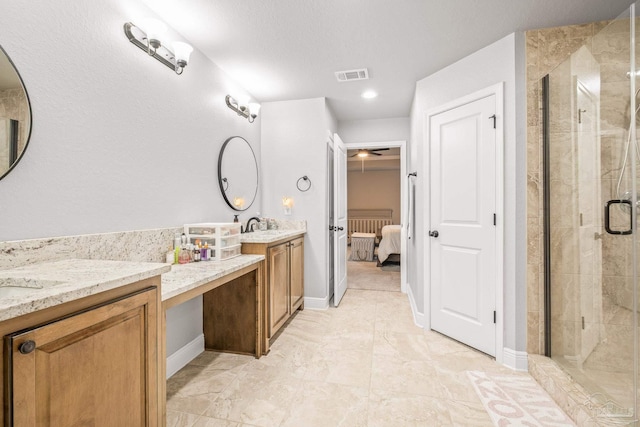 bathroom with vanity and a shower with door