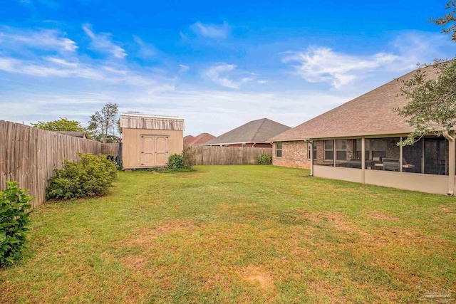 view of yard featuring a storage shed and a sunroom