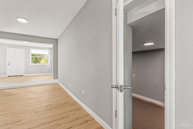 corridor with wood-type flooring