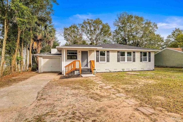 ranch-style home featuring a garage and a front yard