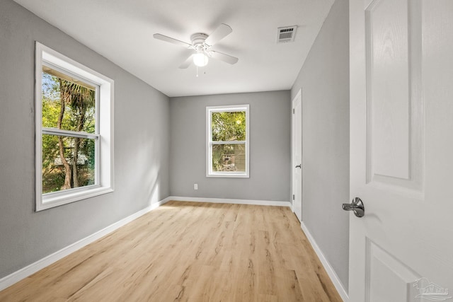 spare room with ceiling fan and light wood-type flooring