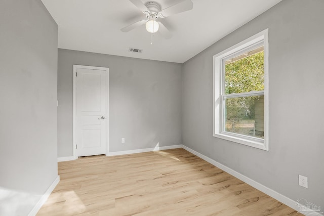 spare room featuring light hardwood / wood-style floors and ceiling fan
